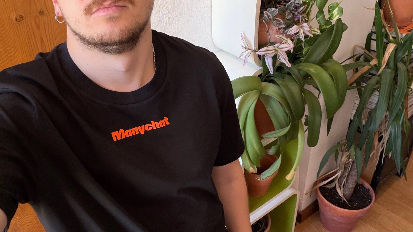 The front of the black T-shirt with a small orange logo on the chest
