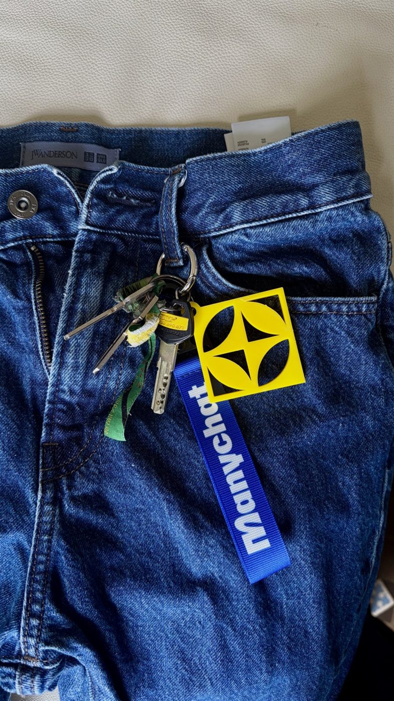 The finished keychain clipped to a pair of jeans
