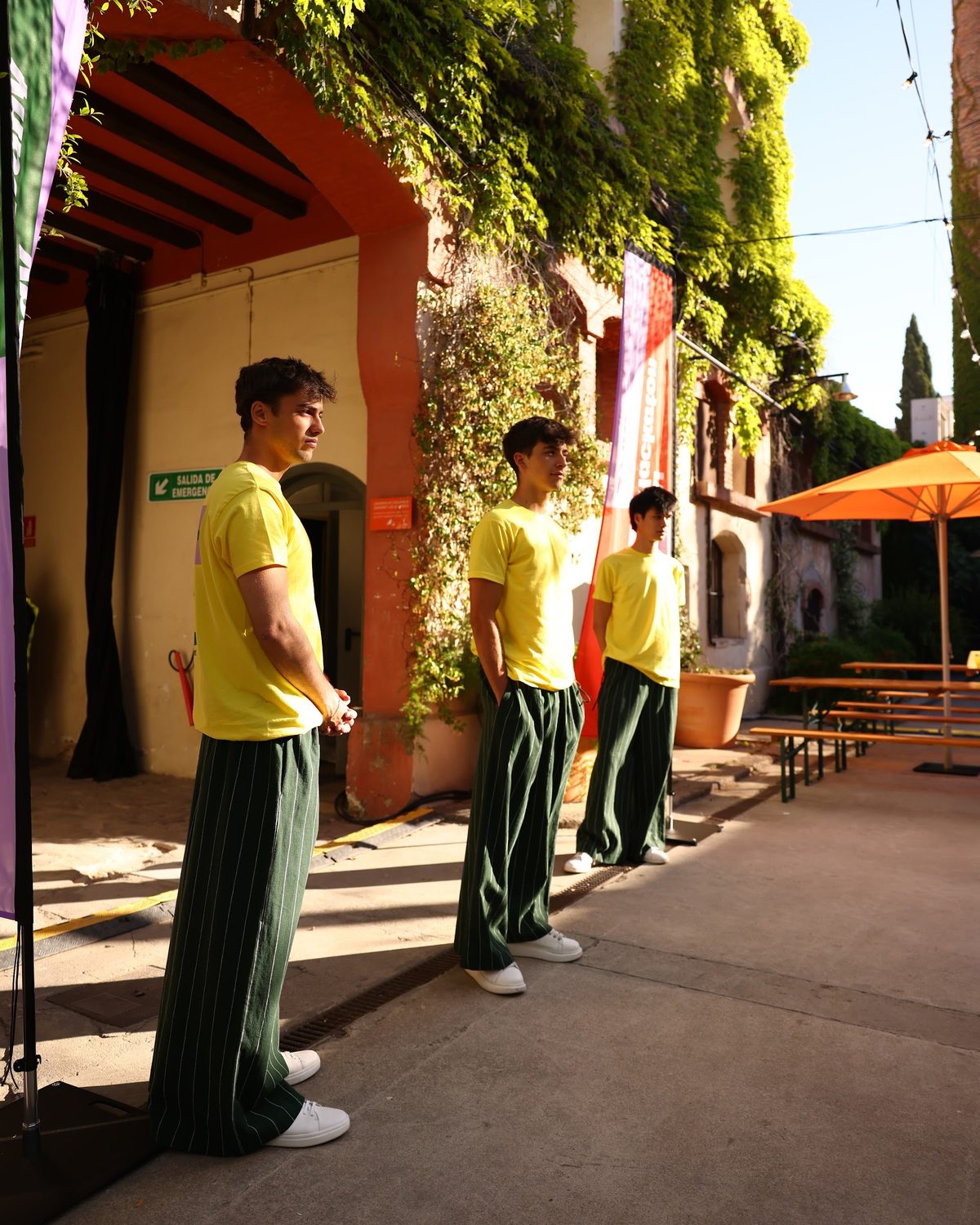 Crew members in the yellow T-shirts standing along the garden walkway