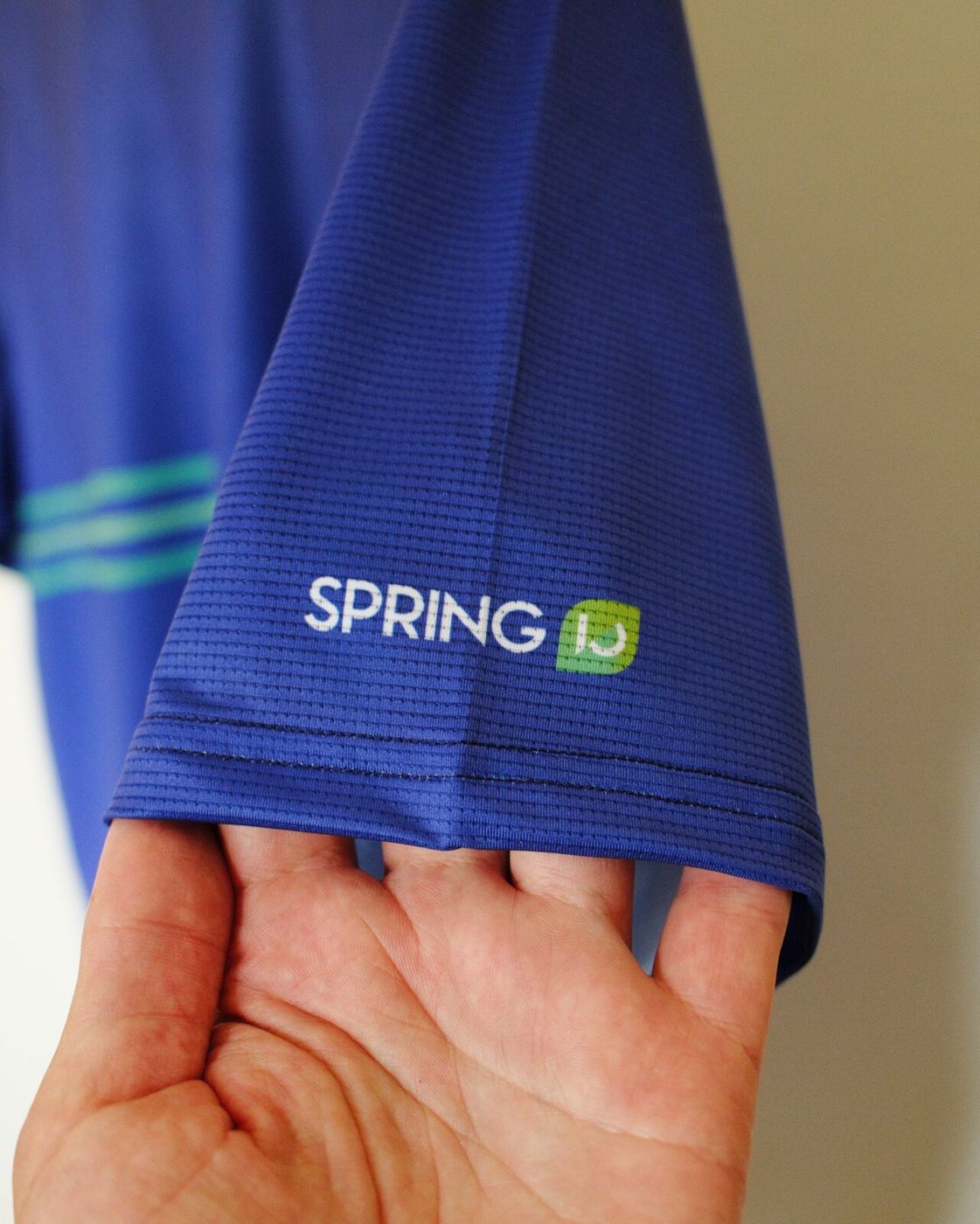 The sleeve with the Spring logo printed in white and green