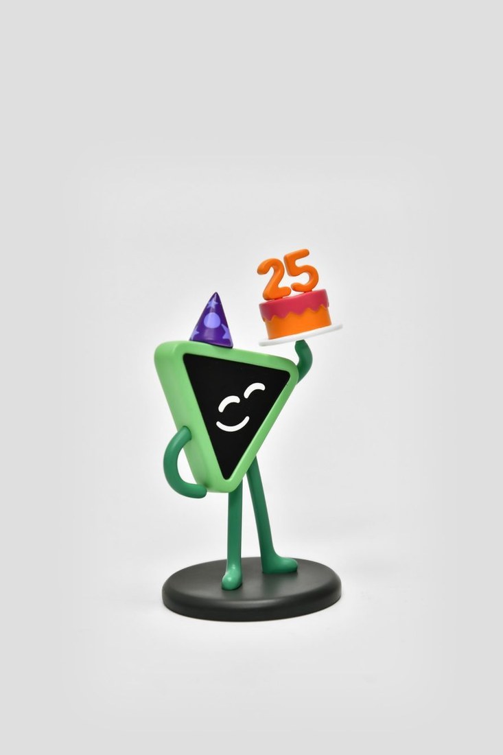 Runzo in a party hat holding a cake with the number 25