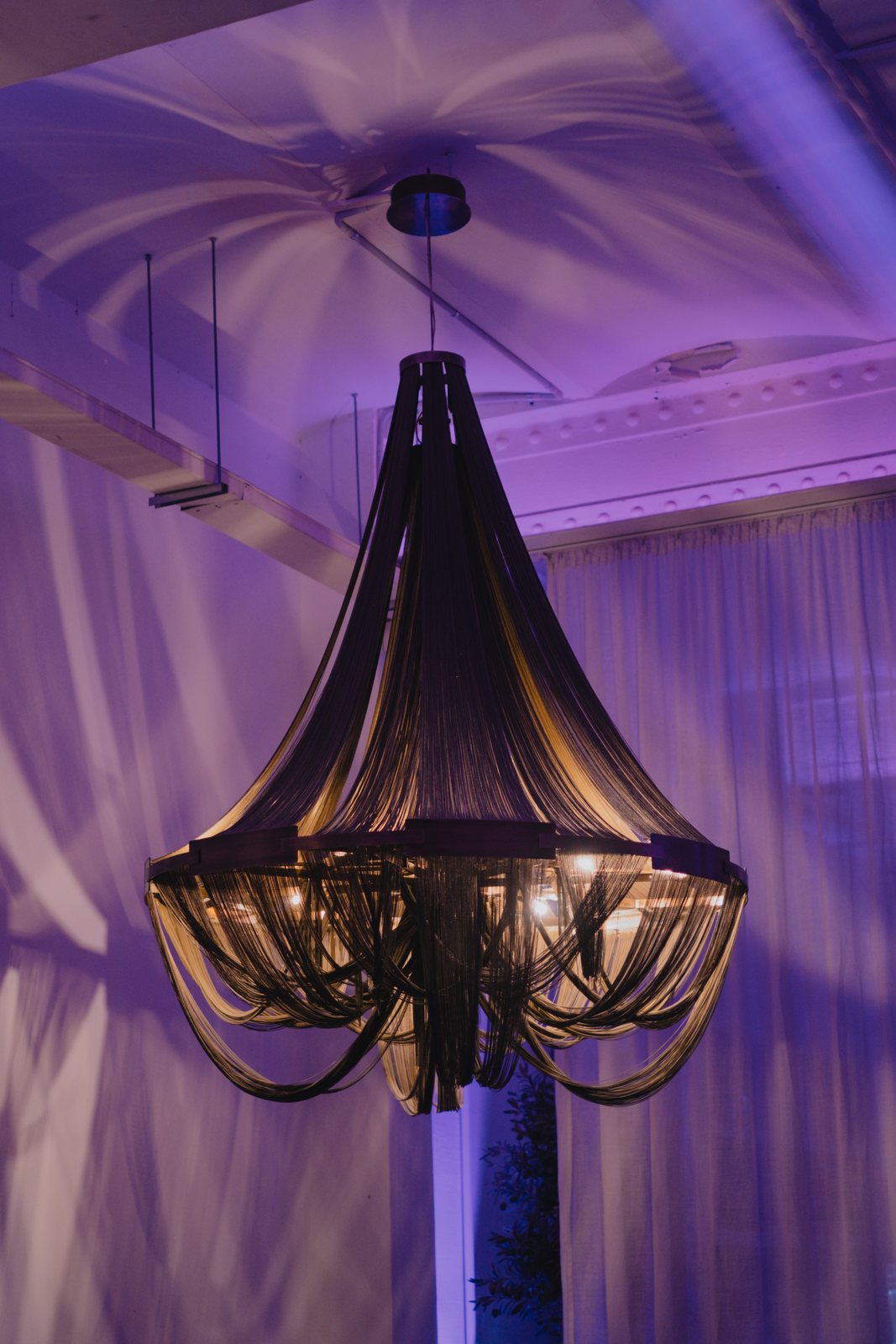 A chandelier in violet light