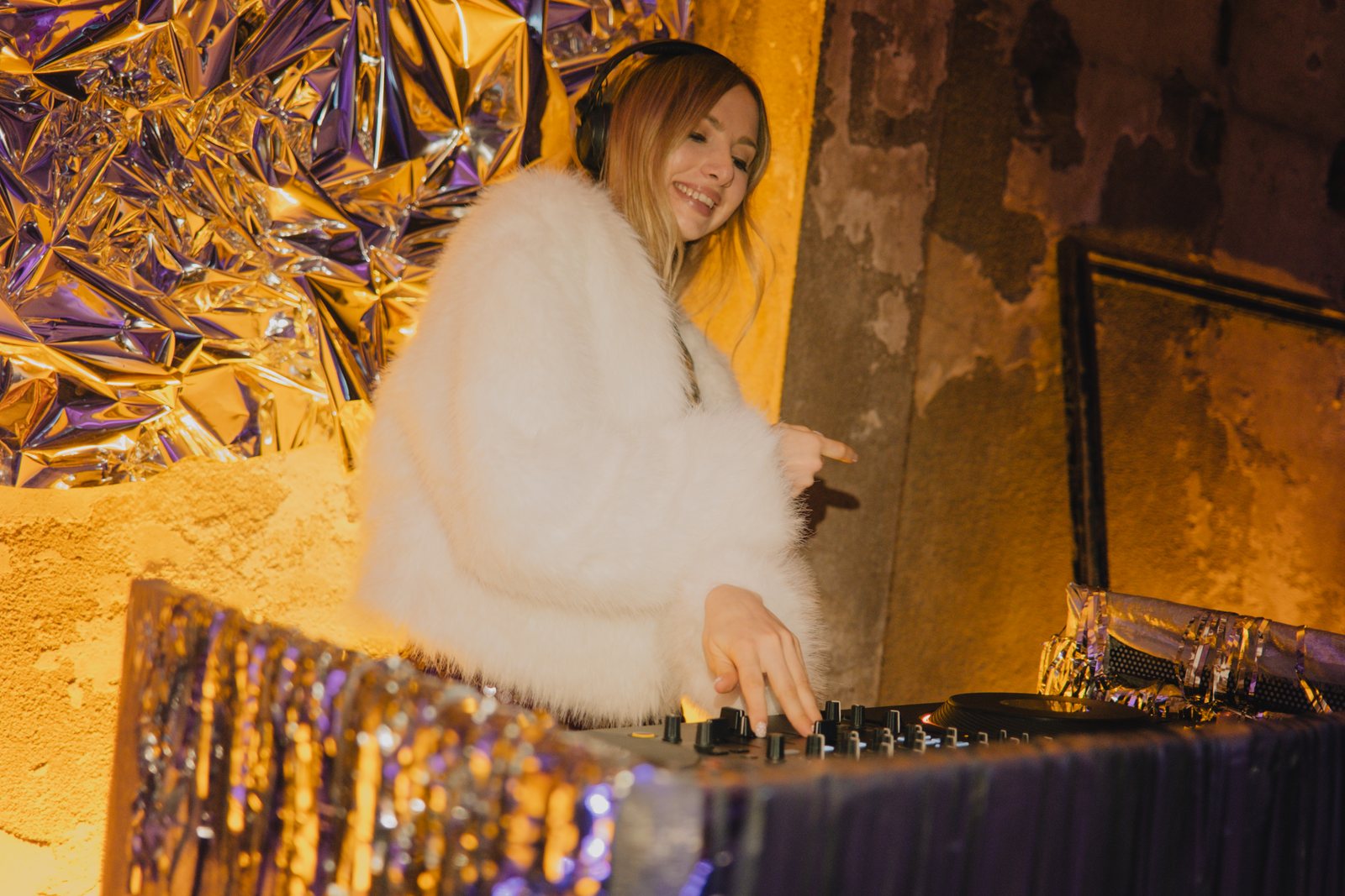 The DJ in front of a silver foil wall
