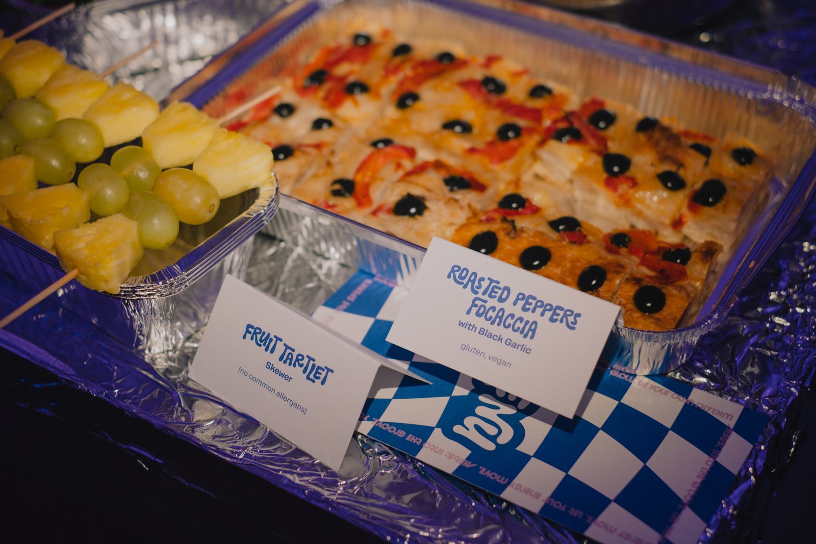 Fruit skewers and focaccia on blue checks