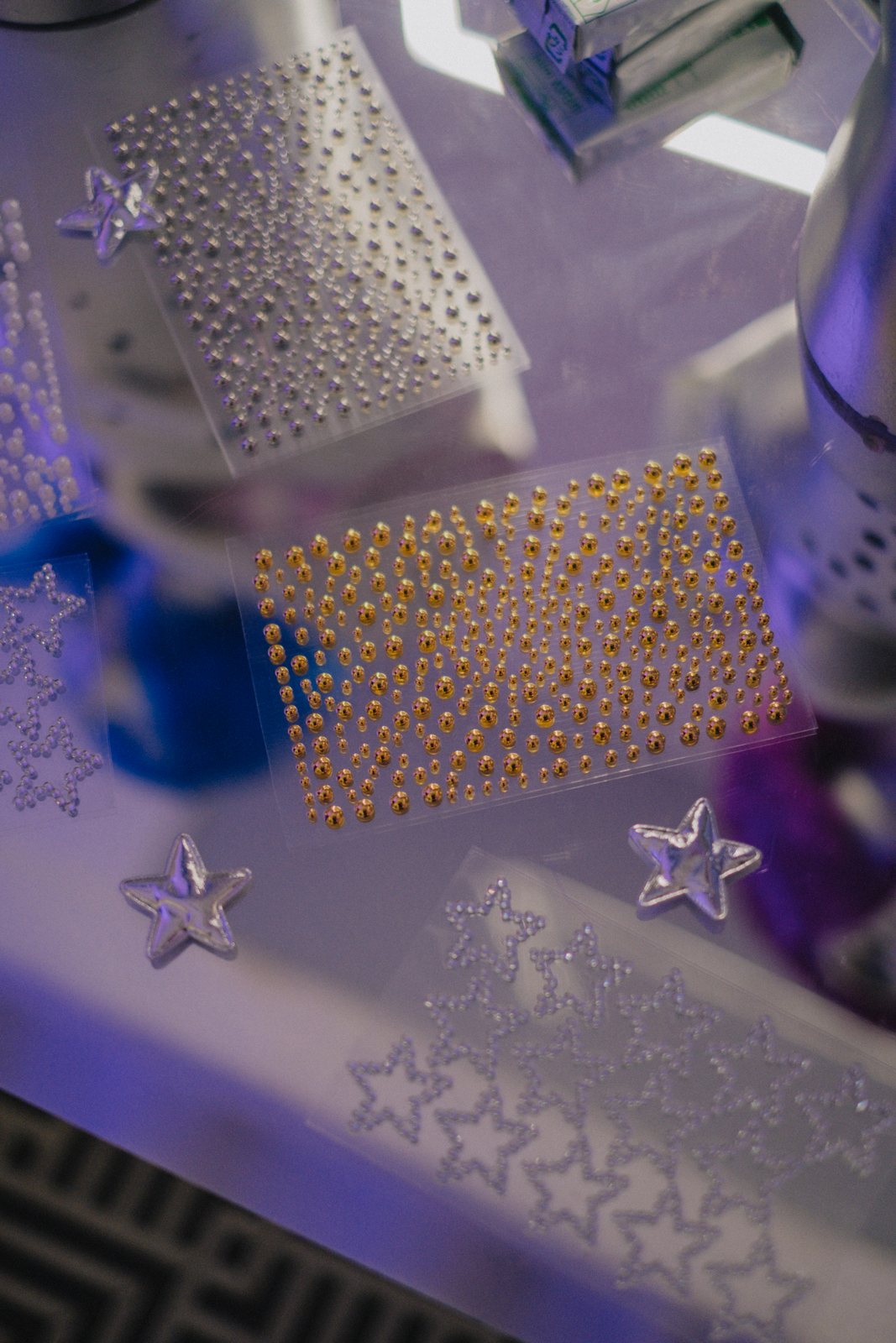 Sheets of gold and silver face gems with silver stars