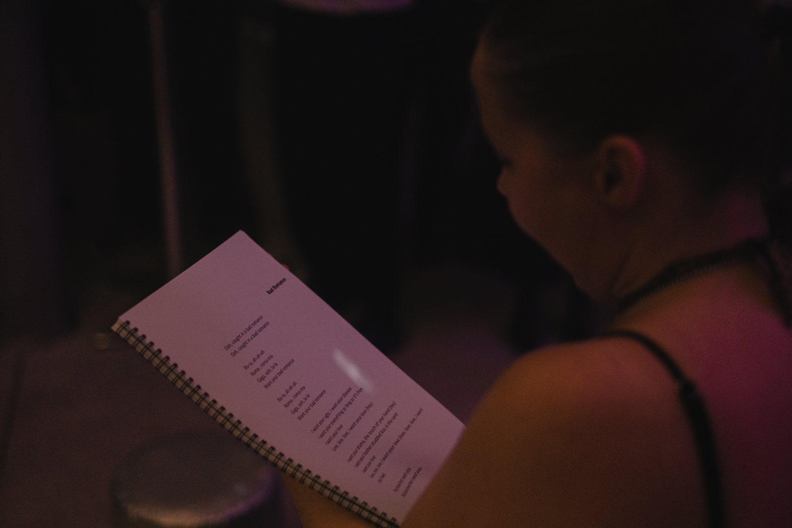 A guest reading the karaoke lyrics