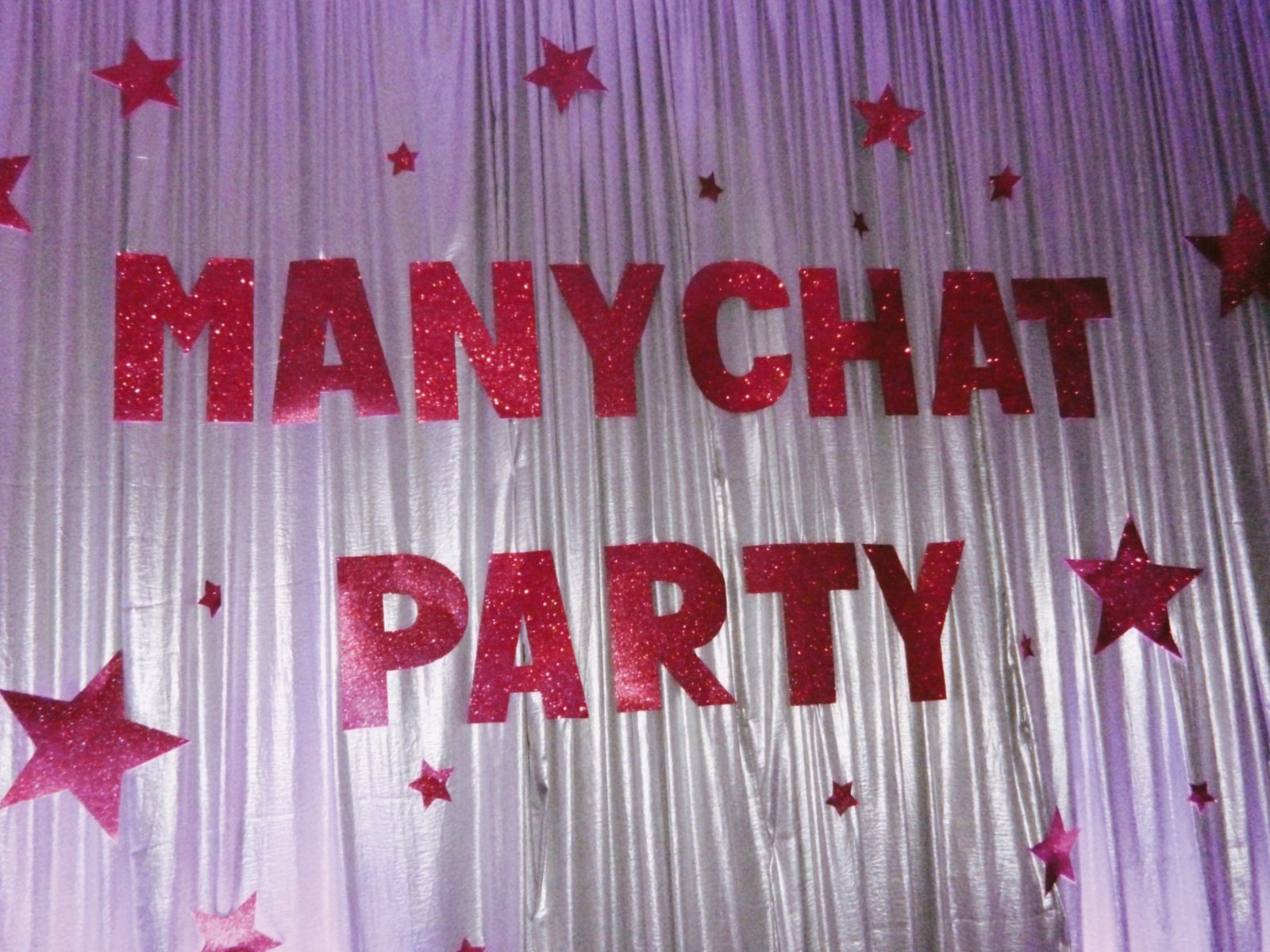 Party lettered in red glitter on a tinsel curtain