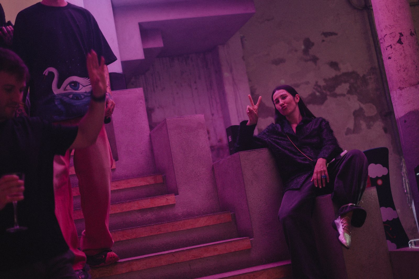Guests on pink-lit stairs