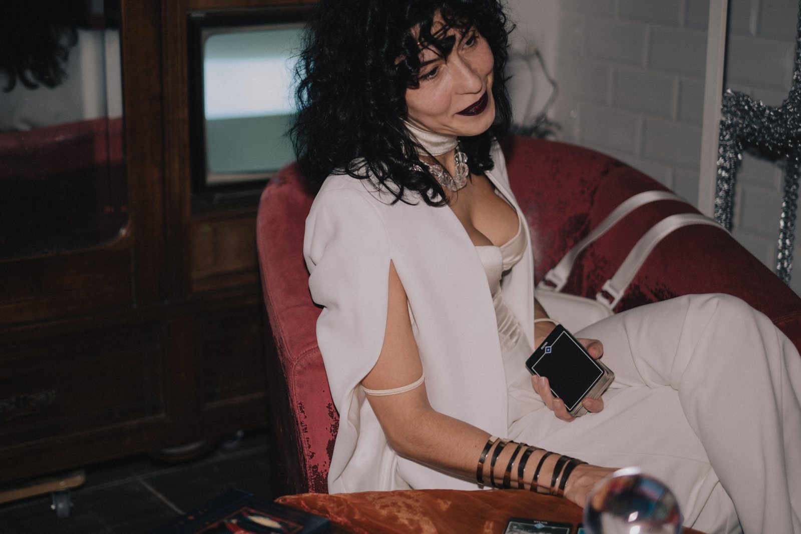 The fortune teller in white on a red armchair