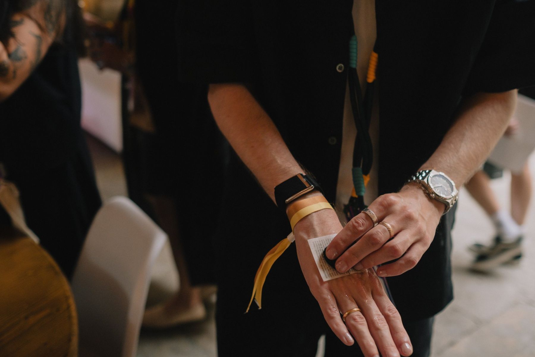 A wristband being stamped on a guest's hand