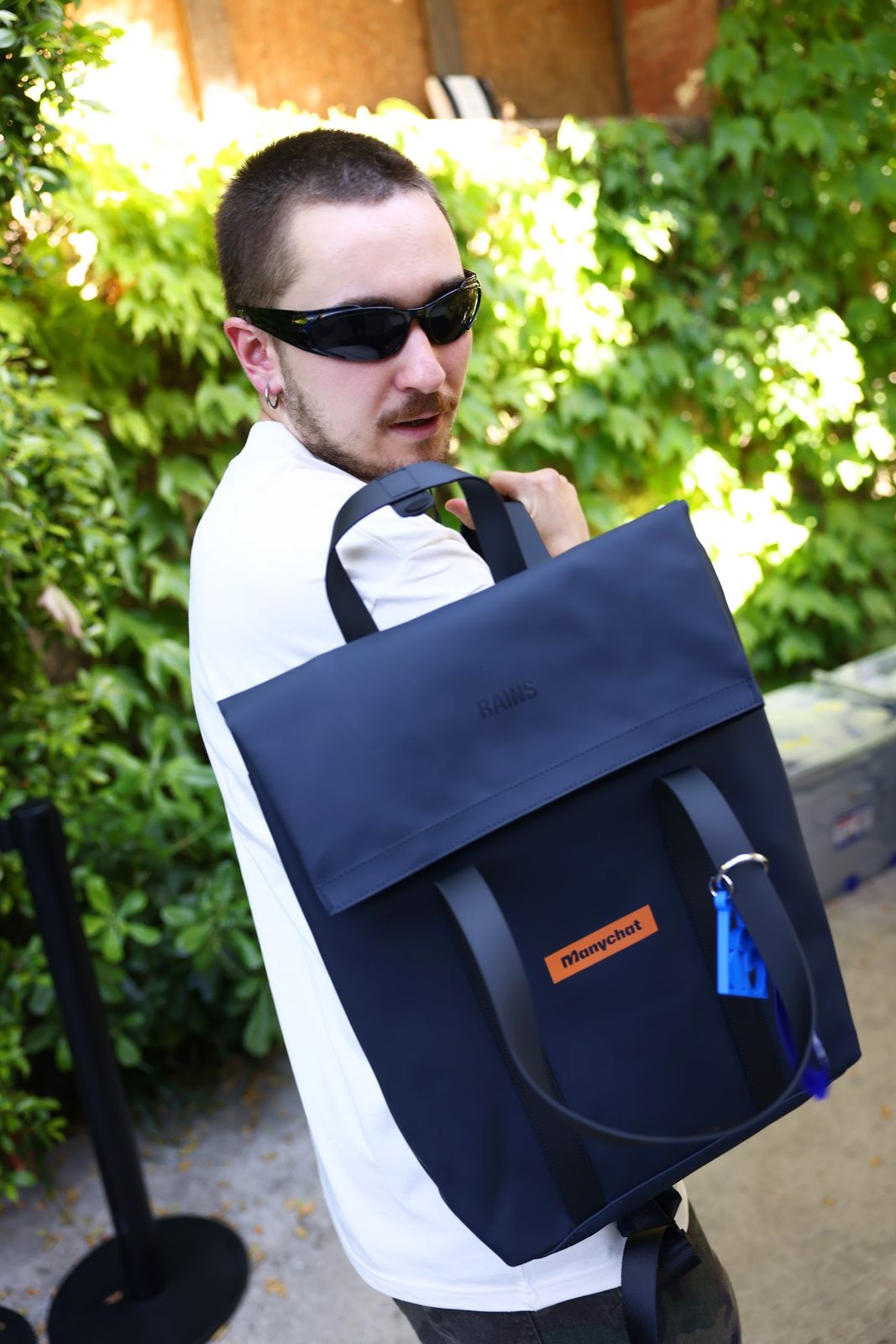 A man holds up the navy welcome backpack