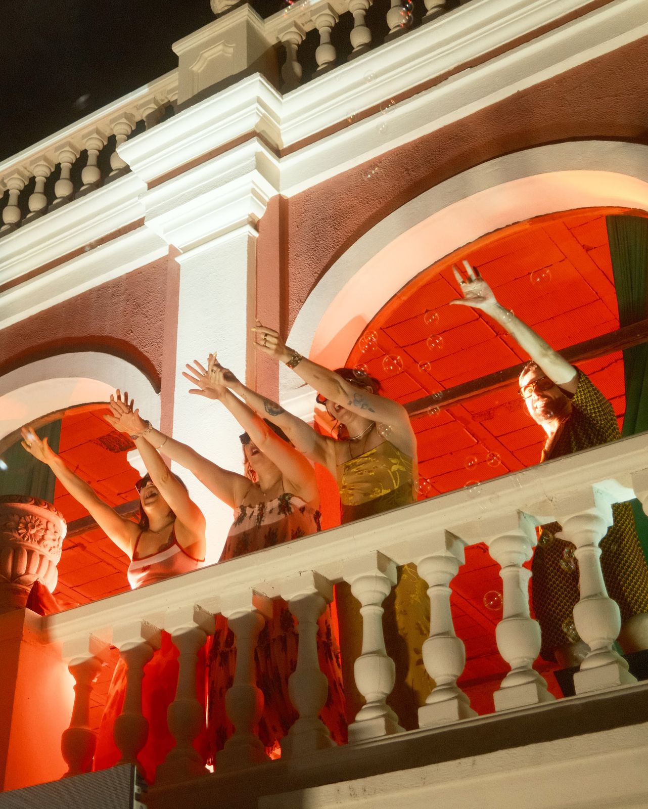 Dancers in orange on the castle balcony