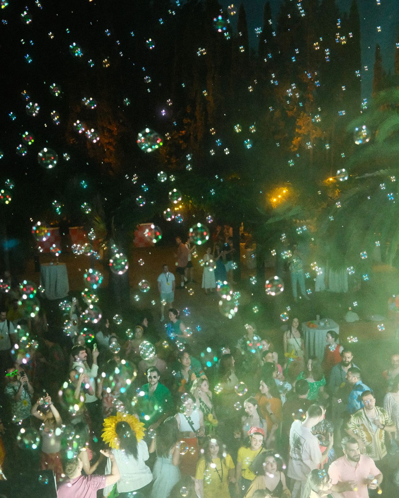 Bubbles floating over a dancing crowd
