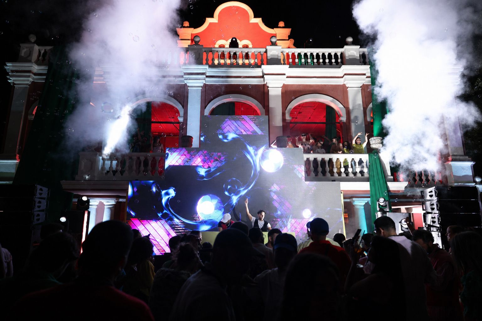 Smoke jets and lights in front of the castle at night