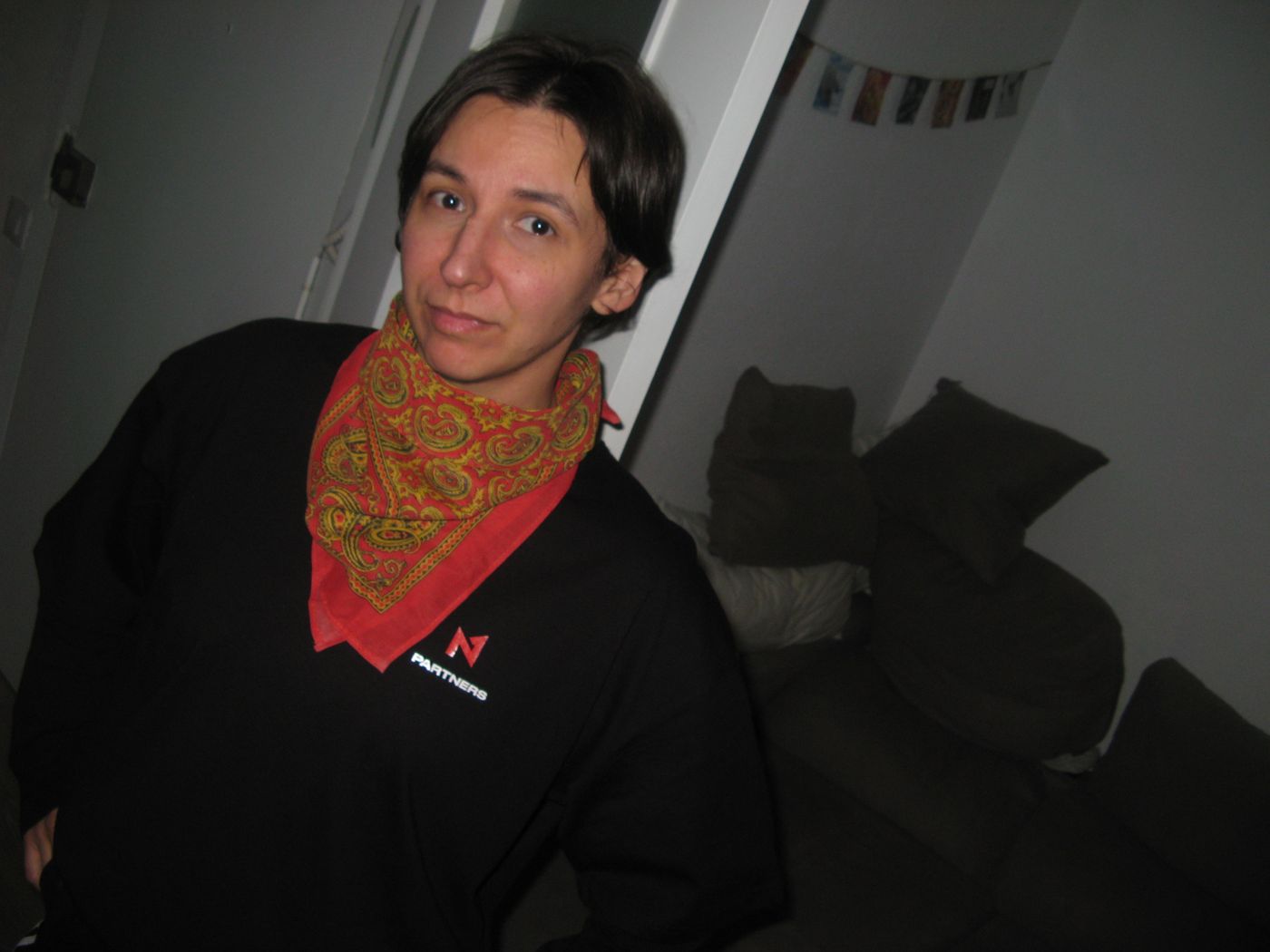 A crew member in the N1 sweatshirt and a red bandana