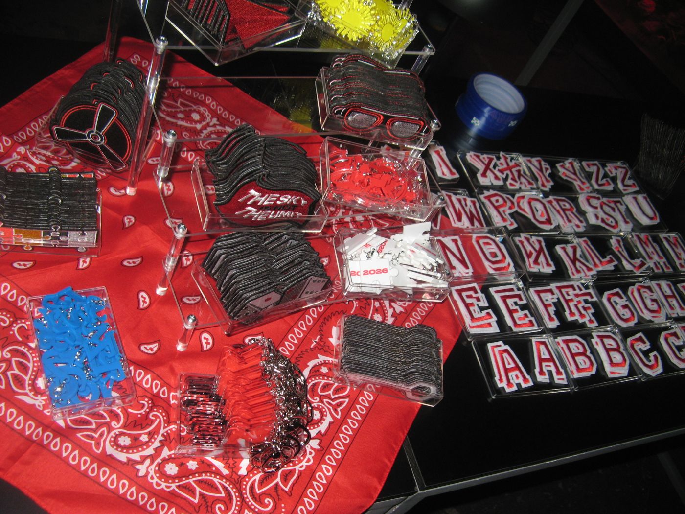 Varsity letters and patches laid out on red bandanas