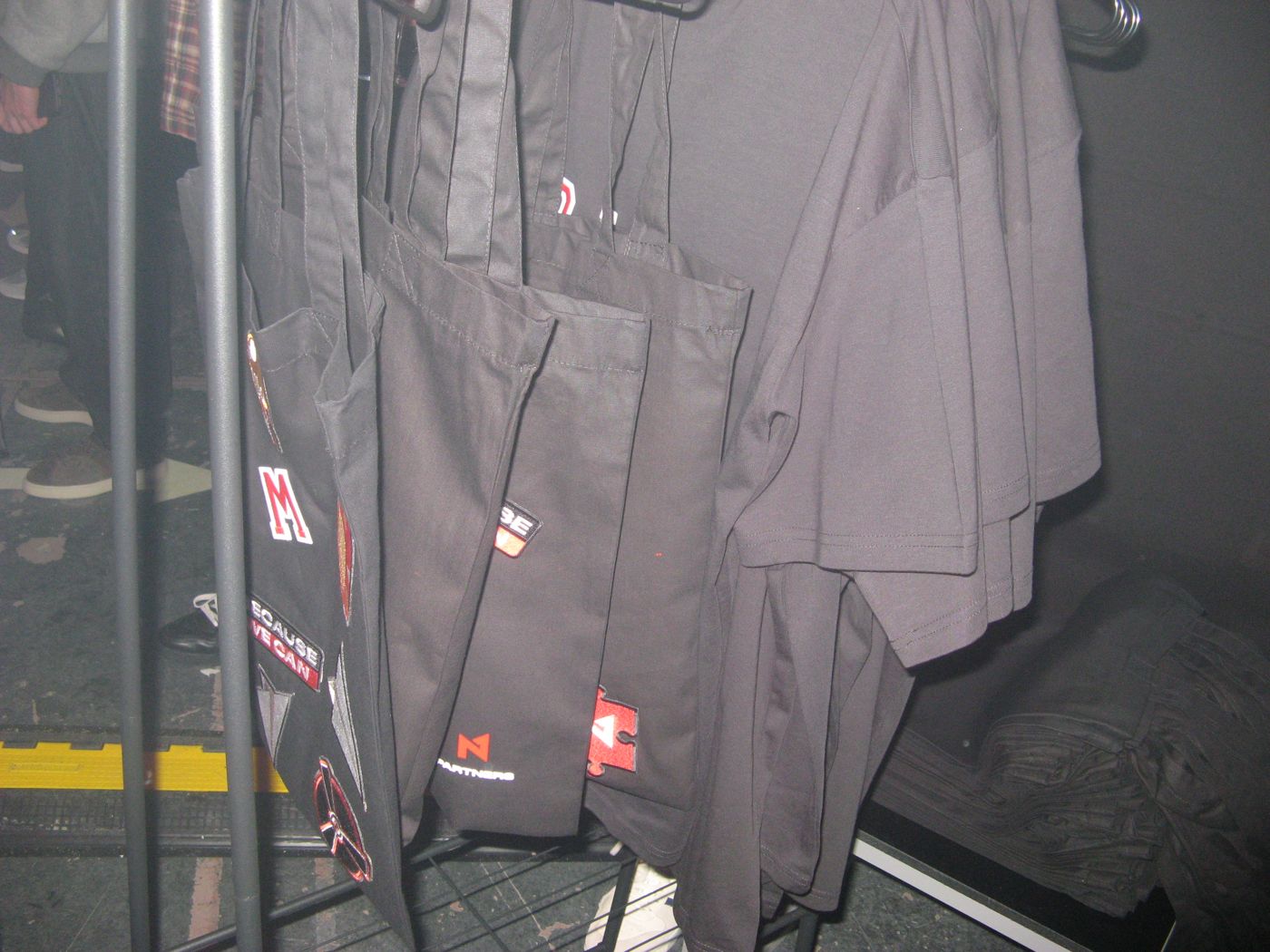 A rack of black tote bags