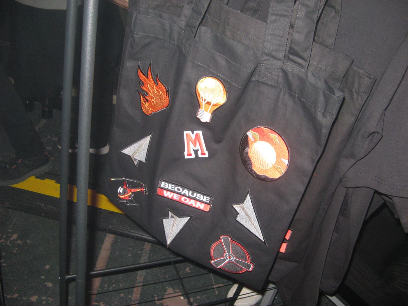 A finished tote with flames, a bulb, an M and paper planes