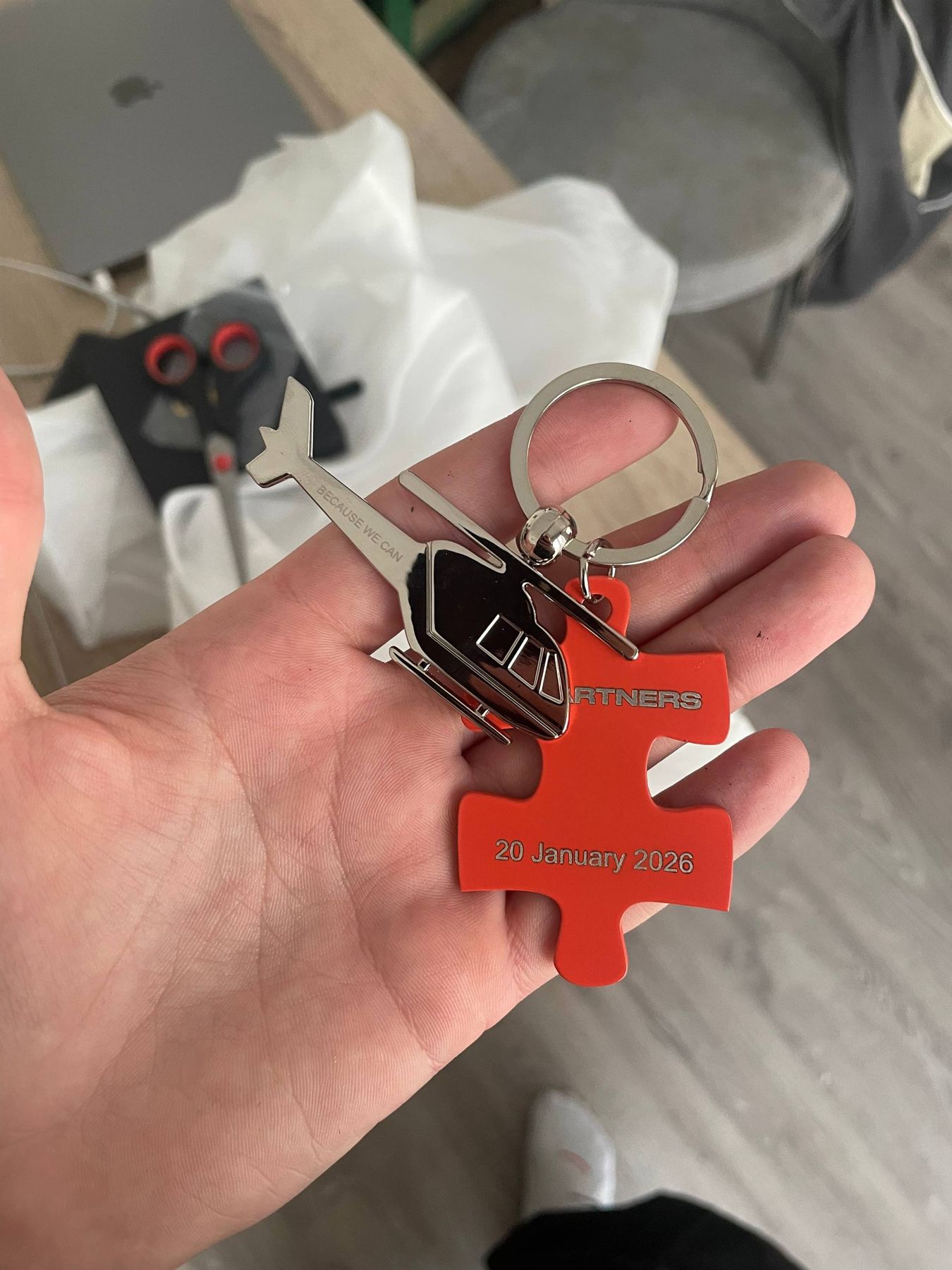The red N1 puzzle keychain held in a hand