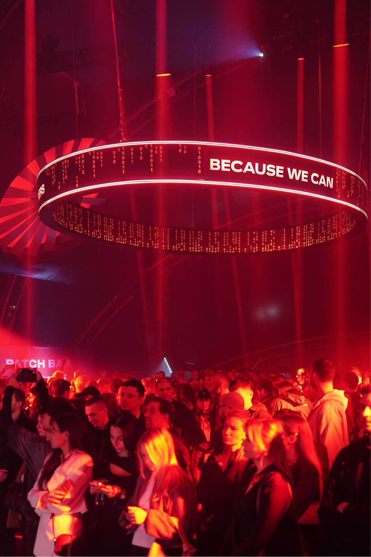 The Because we can light ring over a crowd in red light